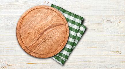 Empty vintage pizza board and napkin on planks.