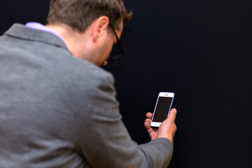 Side view close up Businessman Use Smartphone Black Background