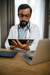 consultation of a doctor on tablet and computer