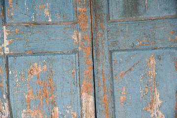 Background old cabinet door with falling blue paint.