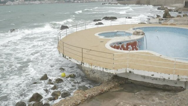 Abandoned swimming pool with graffitties
