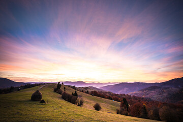 Mountain valley landscape under beautiful colorful sky.