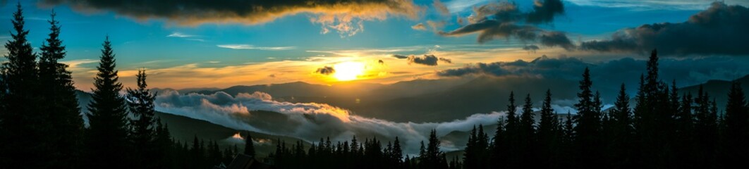 Beautiful sunset in mountain forest wide panorama © YouraPechkin