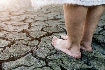 bare feet on cracked desert soil