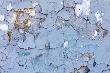 Obraz premium Abstract creative background of chaotic strokes of old cracked paint on concrete wall. Old surface with traces of paint, weathered, scratches and cracks for design