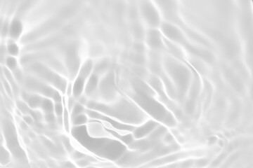Closeup of desaturated transparent clear calm water surface texture with splashes and bubbles....