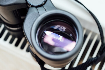 Ñloseup view of a binocular lens with a beautiful abstract reflection. Conceptual minimalism,...