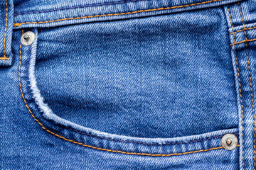 Jeans front with pocket. Bright blue denim fabric texture background. Closeup view