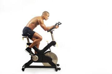Fototapeta na wymiar man on bicycle simulator doing exercises isolated on white background