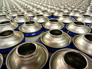 close up of empty steel aerosol cans in factory