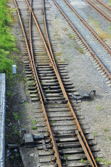 Fototapeta premium Trains at railroad yard at station district Industrial background featuring detail of electrical railroad with rails and contact lines. Modern, bridge. 