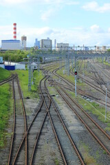 Fototapeta na wymiar Trains at railroad yard at station district Industrial background featuring detail of electrical railroad with rails and contact lines. Modern, bridge. 