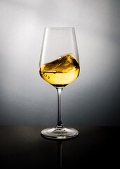 Golden Color White Wine Swirled in a Glass