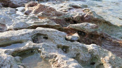 water flowing over a stone rock surface