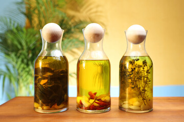 Olive oil with herbs. A composition of bottles with fresh olive oil and herbs.