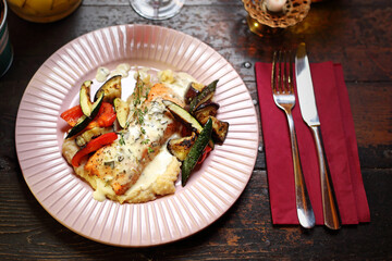 Salmon with grilled vegetables on vegetable puree.
Appetizing dish. Suggestion of serving a dish. Culinary photography.