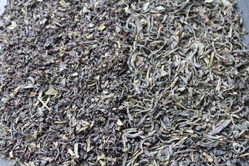 background of food tea black and green large leaf and small leaf scattered evenly with additives