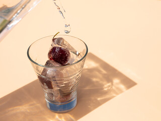 Frozen cherry inside a glass, fresh drink and summer concept