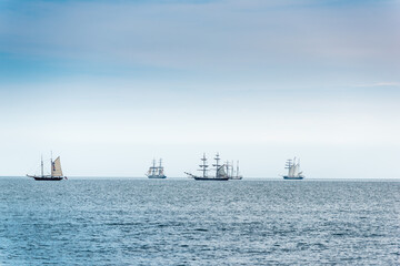 Tall Ships on blue water. Tall ships parade.