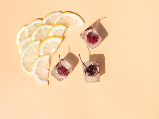 Lemon slices and frozen cherries isolated on a light background