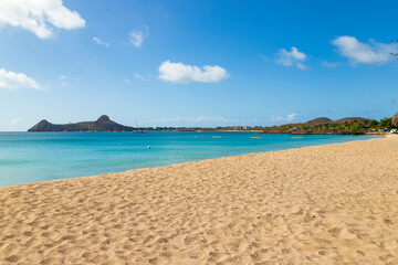 Fototapeta na wymiar Vacation beach scenery with a headland in the background