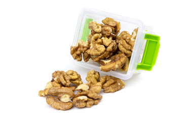 Kernels walnut isolated on a white background. Peeled walnut in a container.Healthy food. Plastic container with walnut.