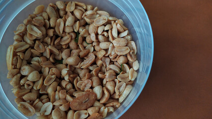 Salted roasted beans in a bowl with a brown background