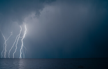 Naklejka na ściany i meble lightning over the sea in the night