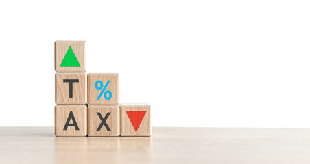 Wooden blocks with the word Tax and up and down arrow.