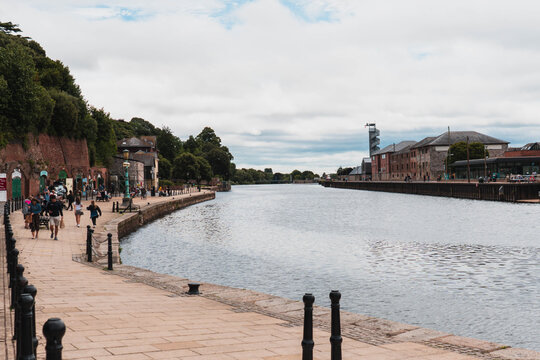 The Quayside shops and walking path along the River Exe in Exeter, Devon, UK