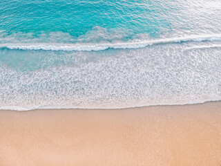 Top view on the beach with wave foam