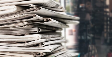 Pile of fresh newspapers on a blur background