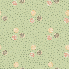 Pastel childish pattern with yellow, green and orange spirals. Green background with dots.