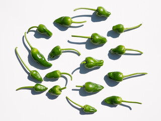 Few fresh padron peppers isolated on white background