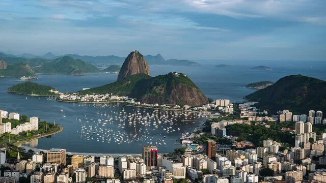 Rio de Janeiro, Brazil, sunset timelapse view of Rio cityscape including natural landmark Sugar Loaf Mountain and Guanabara Bay during summer. 