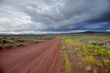 A desert road constructed of red volcanic cinders, east of Bend, Oregon.