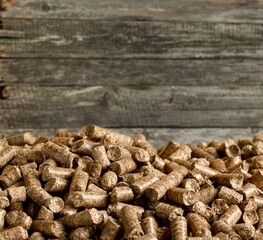 Wood chip pellets on wooden background