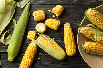 Composition with fresh raw corn on wooden table