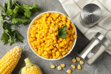 Composition with fresh raw corn on gray background, top view
