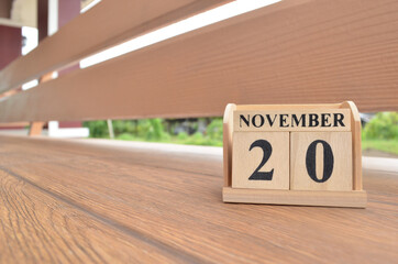 November 20, Number cube with wooden balcony background.