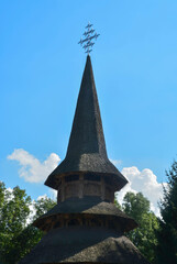 Sapanta Peri Monastery, Maramures, Romania, Europe, summer 2018. Traditional wooden church with the highest bell tower in the world with a maximum height of 78 meters. With a cross on top.