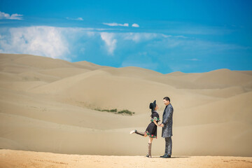 A couple traveling in the desert.