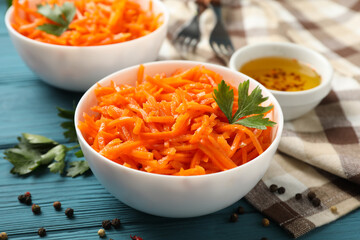 Composition with tasty carrot salad on wooden background. Korean carrot