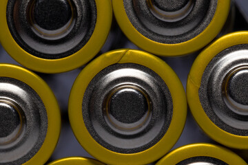 Macro shot of AA batteries yellow on white background
