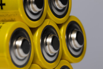 Macro shot of AA batteries yellow on white background