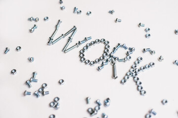 The inscription is the word work lined with bolts and nuts. Bolts and nuts on a white background.