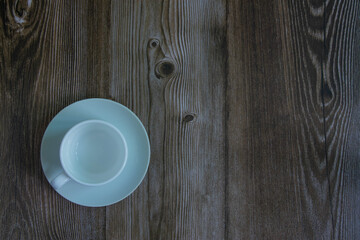 Fototapeta na wymiar A cup of coffee on the wooden background