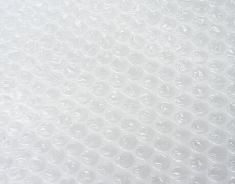 Bubble wrap. Plastic packaging material. Close-up photo. Free antistress. Abstract light background
