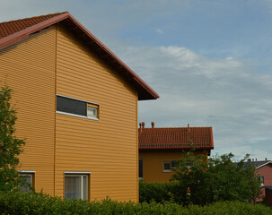 Modern wooden family homes in Espoo, Finland, Scandinavian style design. Lots of trees and bushes create an environmentally friendly neighbourhood.