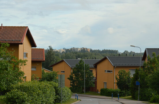 Scandinavian style modern wooden family homes painted in yellow. Photographed in a beautiful neighbourhood in Espoo, Finland.